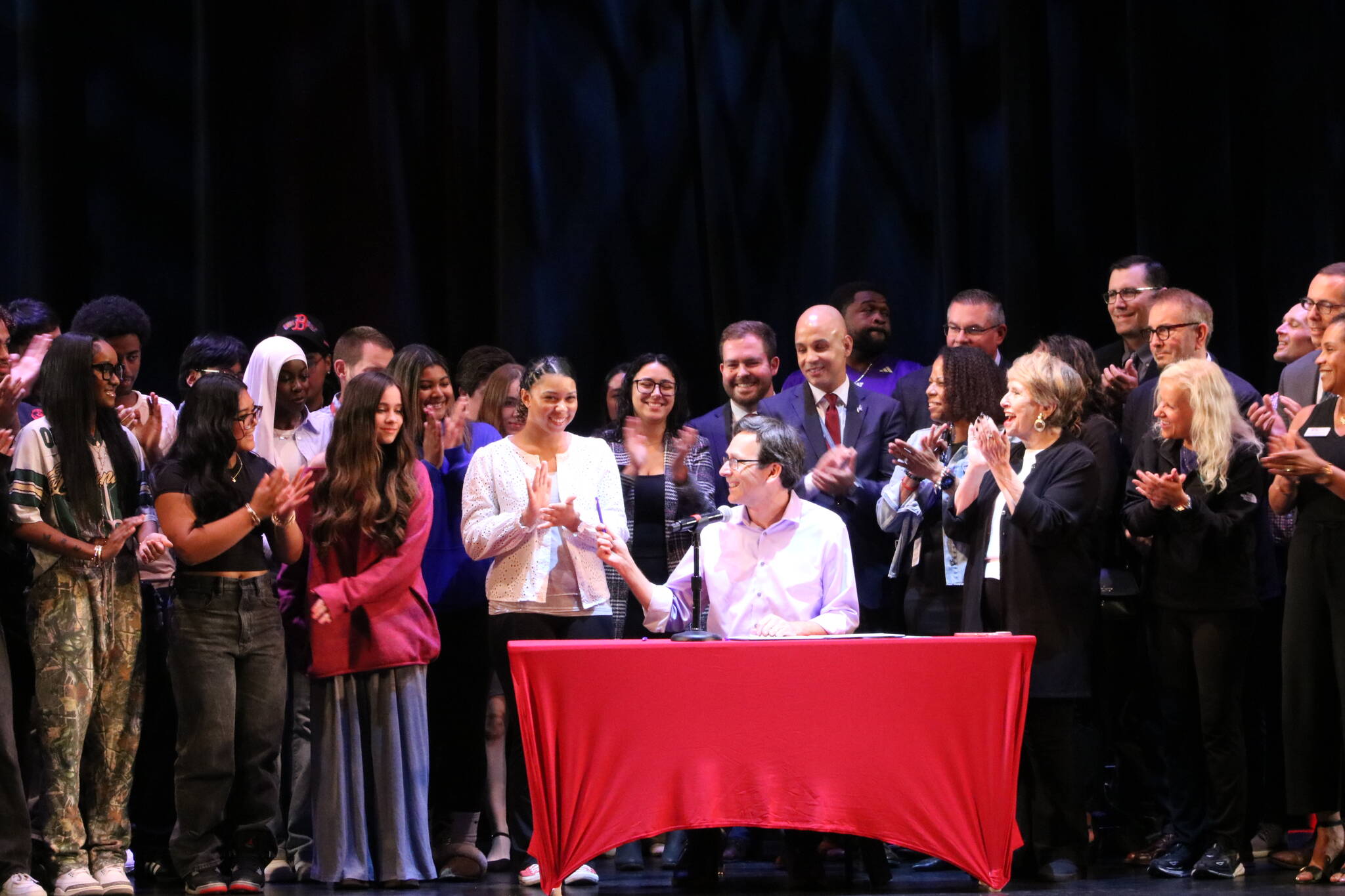 Gov. Bob Ferguson gives student body president Naomi Dancer the pen he used to sign the executive order. Photo by Bailey Jo Josie/Sound Publishing