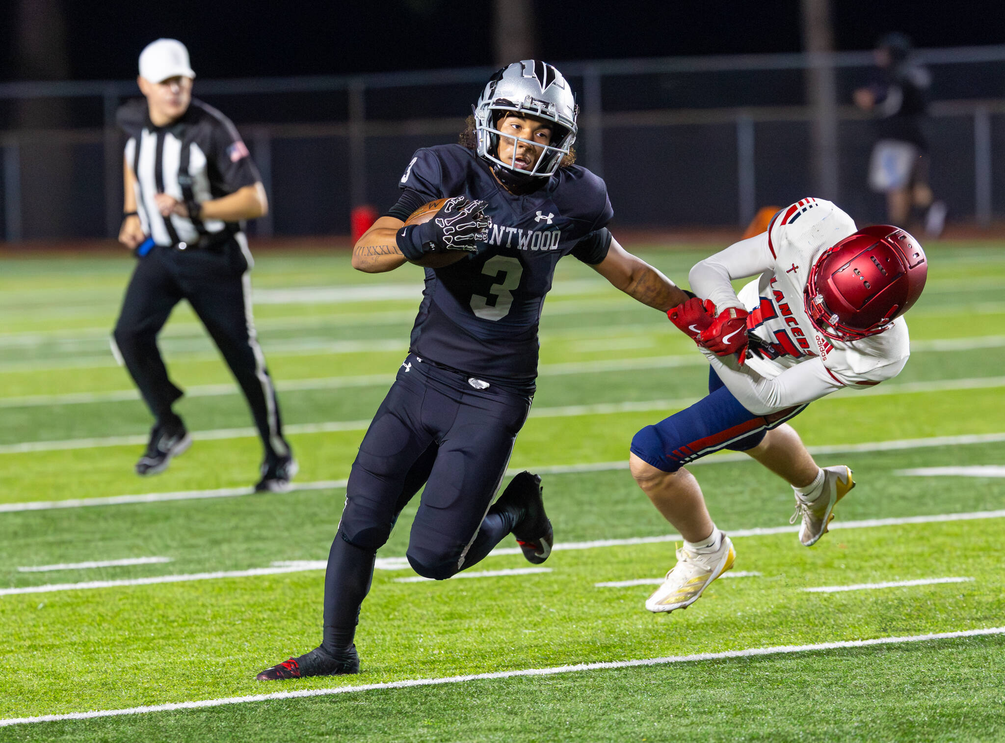 Darian Williams stiff arms a Kennedy defender. Photo provided by Robby Mullikin