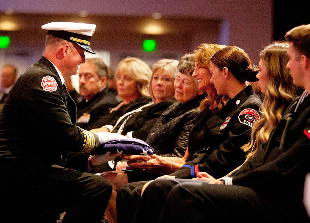 The flag presentation to Pam Webb, the wife of Puget Sound Fire Deputy Chief Jimmy Webb, during a Celebration of Life service Oct. 4 at Christian Faith Center in Federal Way. COURTESY PHOTO, Puget Sound Fire