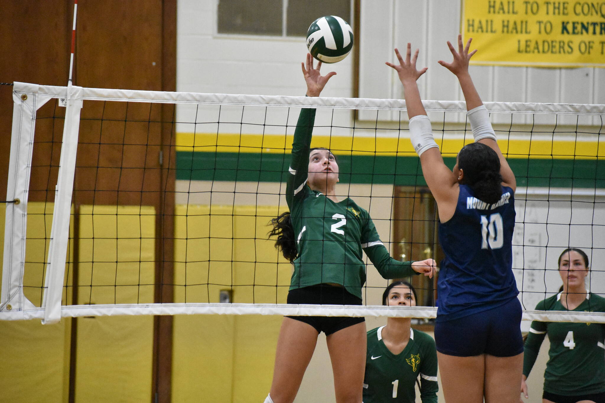 Makana Lum-Lang tips the ball over the net for Kentridge in their match against Mount Rainier. Ben Ray / The Reporter