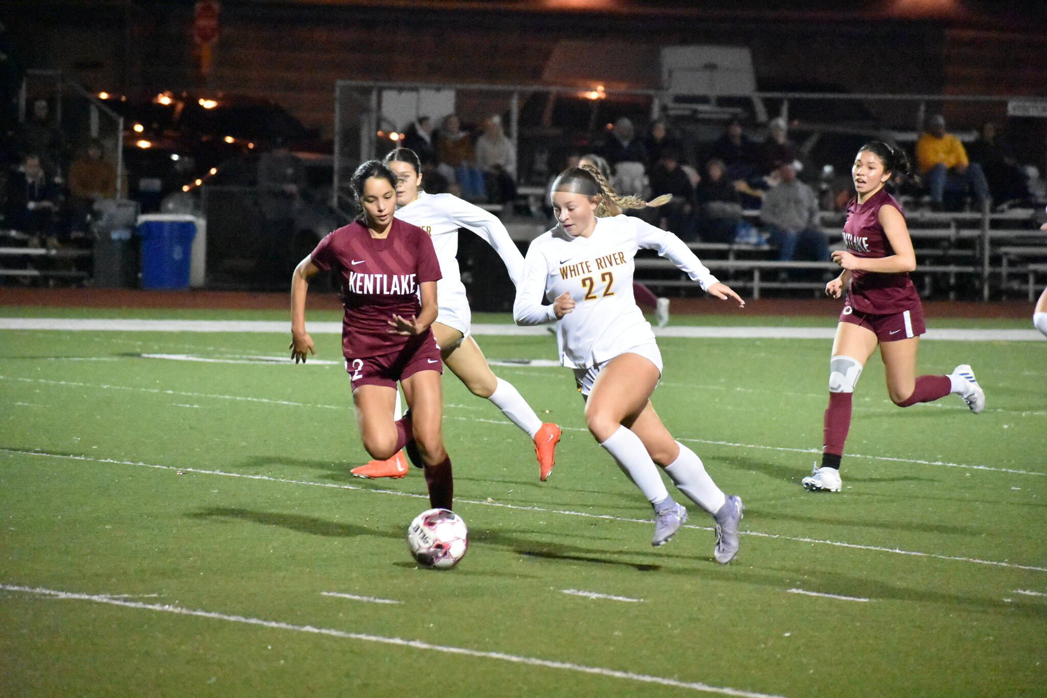Jordyn Daigle and Isabella Cabaccang chase the ball for Kentlake and White River. Ben Ray / Sound Publishing