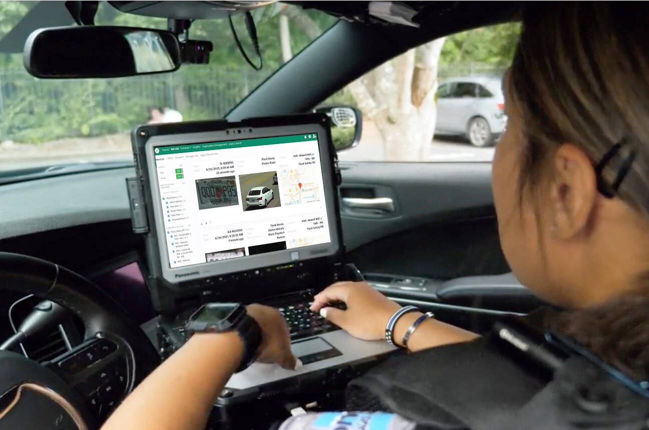 A police officer looks at vehicle information captured by a Flock Safety camera. COURTESY PHOTO, Flock Safety