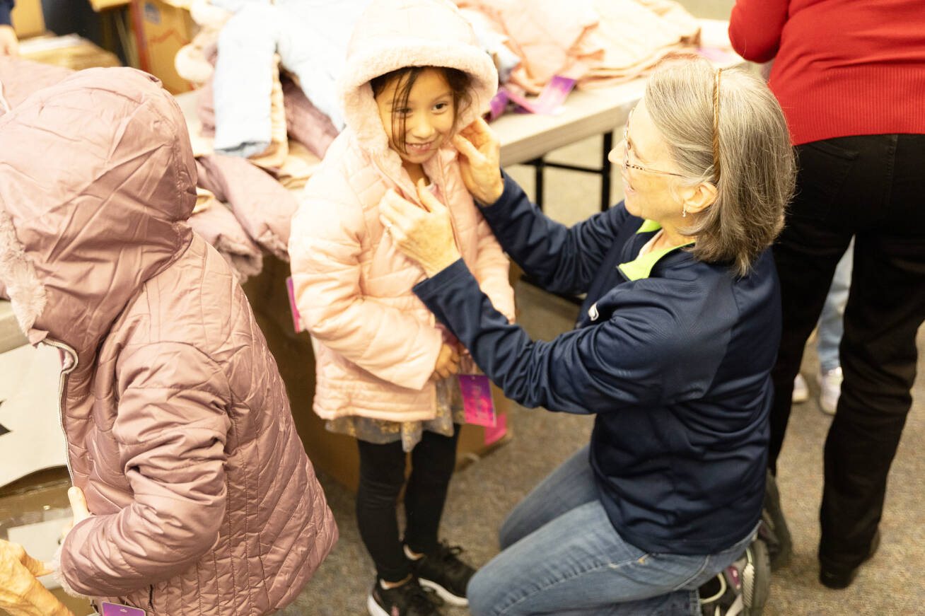 tA student gets fitted with a new coat at Springbrook Elementary School in Kent, part of a donation program by the Knights of Columbus. COURTESY PHOTO, Kent School District