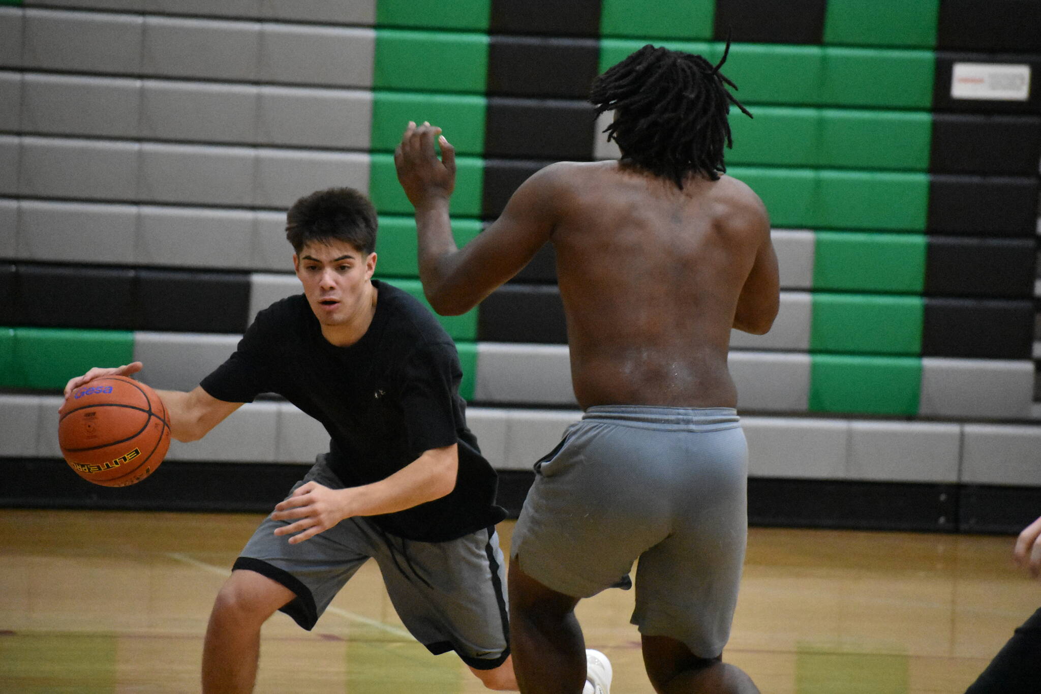 Brandon Tagle drives past a teammate at practice. Ben Ray / The Reporter
