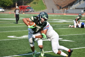 Auburn wide-out Lucas Whitehall-Gilkes takes a hit against the Royals. Ben Ray / Sound Publishing