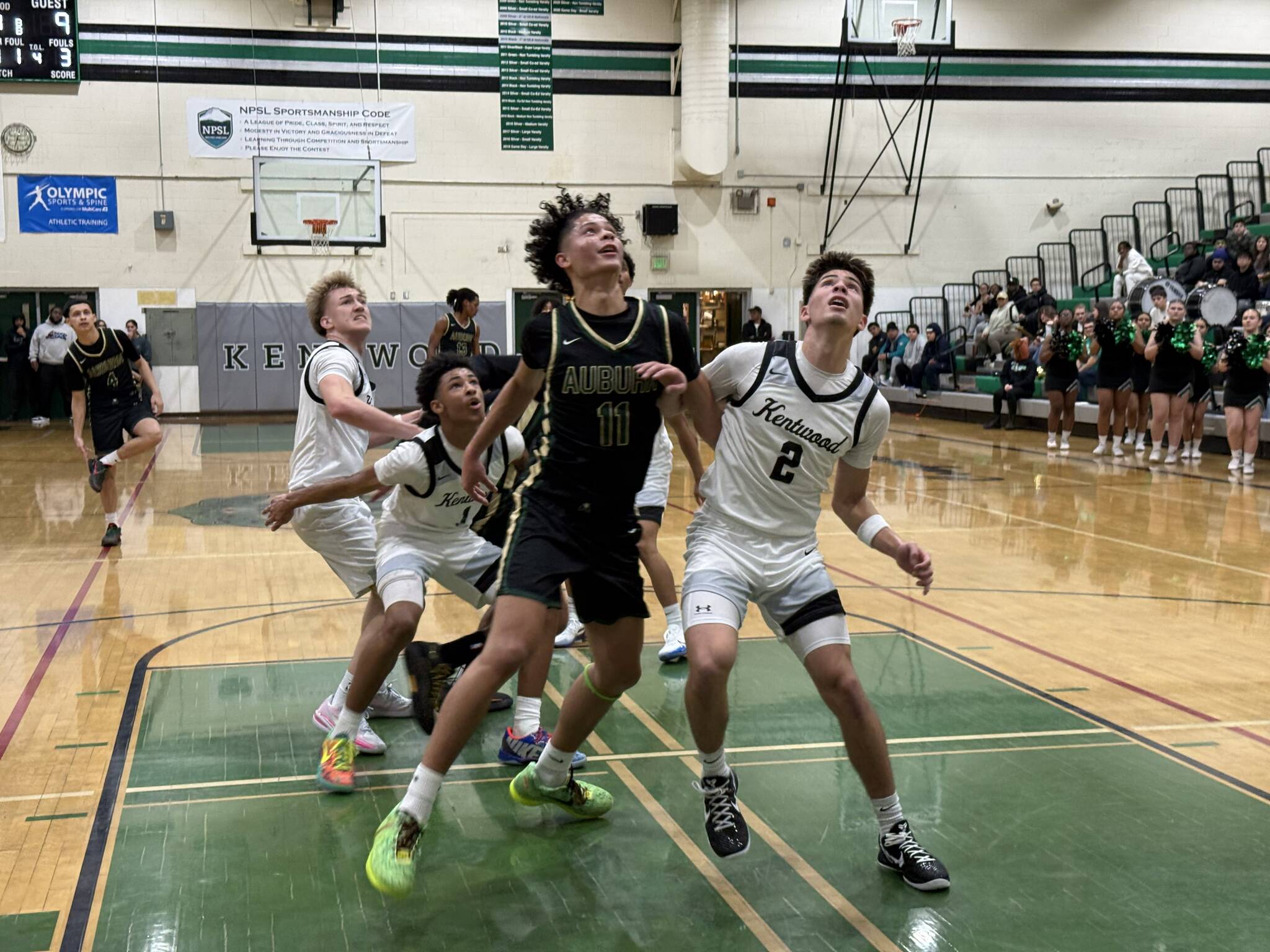 Kentwoods Brandon Tagle boxes out for a rebound. Nathan Hyun / The Reporter