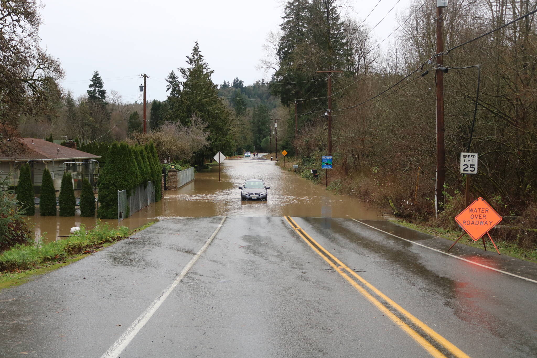 Jones Road near Cedar River has water of the roadway and filling people’s homes from the record-breaking flood. Photo by Bailey Jo Josie/Sound Publishing.