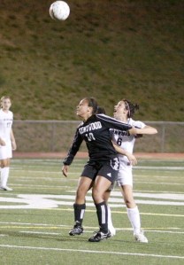 Kentwood’s Clarisa Hammer (front) and Kentlake’s Leanna McCord along with the rest of the Conquerors and Falcons will be sporting pink jerseys for a game on Saturday