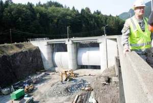 Col. Anthony Wright with the U.S. Army Corps of Engineers stands on a control-tower bridge at Howard Hanson Dam for an interview September 23. Behind Wright are the spillway doors for the dam. The corps is completing work on a temporary measure to bolster an abuttment at the dam