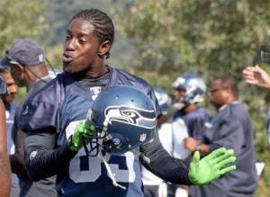 Seahawks wide receiver Deion Branch has fun on the sidelines at a training camp practice Aug. 3 at the Virginia Mason Athletic Center in Renton. The practice was the first- ever training camp session open to fans at the VMAC.