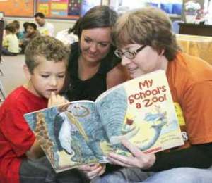 United Way Day of Caring volunteers read to first and second graders at Daniel Elementary