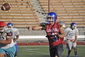 Kent-Meridian quarterback Ben Woods delivers a pass at practice Monday. Woods and a core group of seniors hope to lead the Royals to another winning season.
