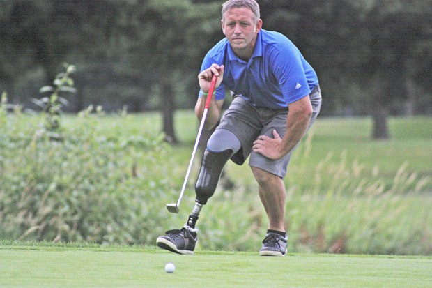 Danny Stevens follows his putt on the 17th hole at Riverbend during the 12th annual Western Amputee Golf Tournament last weekend. Stevens is an avid golfer who shoots a good game.
