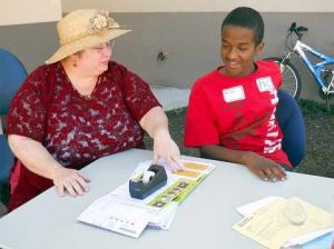 Mill Creek Middle School teacher Sharon Clark talks Aug. 24 with student Billeh Scego during orientation at the school.