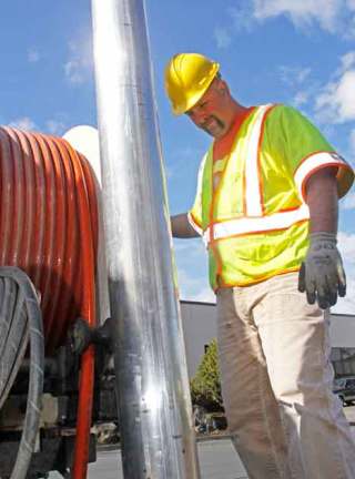 City of Kent sewer maintenance worker Duane Oliver prepares to clean out a sewer at a commercial complex off of 196th. Oliver uses a special vacuum truck to keep the city's sewer pipes clean. CHARLES CORTES