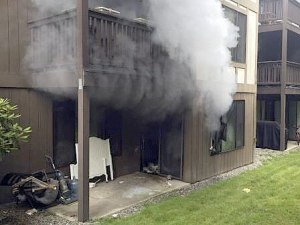 Smokes shoots out of an apartment Thursday morning in the 11100 block of Southeast 256th Street on Kent's East Hill. Nobody was injured.
