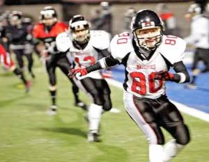 Seattle Majestics player Camille Head shuffle-steps across the field with her team to warm up at practice last March. The Kent-based team