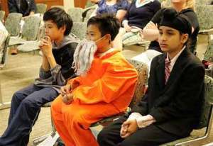 Herschel C. Lyon (Nicolas Morales) is flanked by two of his “attorneys” Ryan Tsing (left) and Kultar Singh (right) during the June 2 mock trial event at the Tukwila Courthouse.