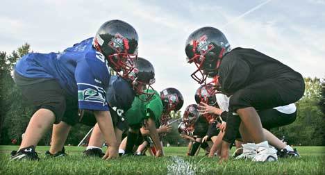 Kent Knights Sweet Peas players line up for a hitting drill at Kent-Meridian High School’s practice fields Thursday. The fields may be getting an upgrade – and more use – as the city of Kent seeks more space for local teams.