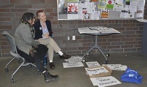 Green River College faculty members distribute signs and T-shirts prior to the Board of Trustees meeting on Wednesday.