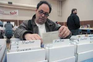 Bellevue resident Stu Jacobson (lower right) looks through vintage postcards at last year’s Greater Seattle Postcard and Papers Collectibles Show. The show returns to Kent this weekend