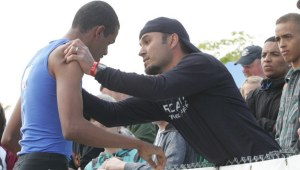 Kent-Meridian's Derrick Daigre gets consoled by track coach Ernie Ammons after taking second in the 800 meters last May during the Class 4A state championship meet at Mount Tahoma High School in Tacoma.