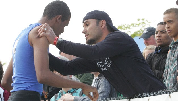 Kent-Meridian's Derrick Daigre gets consoled by track coach Ernie Ammons after taking second in the 800 meters last May during the Class 4A state championship meet at Mount Tahoma High School in Tacoma.