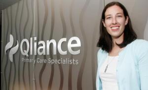 Qliance Marketing Associate Meg Tronquet leads a tour of the the health-care firm's facilities Wednesday at Kent Station.