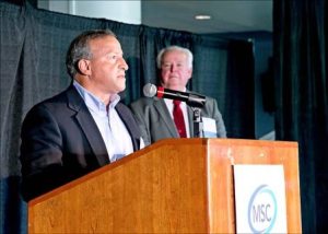 Kent City Councilman Jim Berrios speaks at a Multi-Services Center fundraiser luncheon on Oct. 22 at Emerald Downs as former Auburn mayor Pete Lewis looks on.