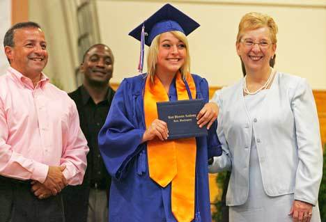 Kent Phoenix Academy graduate Amanda James poses with Kent School Board President Jim Berrios