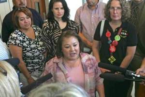 Kent Education Association President Lisa Brackin Johnson gets rushed by television crews as she walks out of court Thursday. At Thursday's session