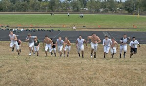 Kentridge High football players charge up a hill during a recent conditioning drill. The Chargers open the season against South Kitsap in a nonleague game at 7 p.m. Thursday
