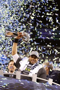 Seahawks quarterback Russell Wilson holds the Vince Lombardi Trophy following a 43-8 Super Bowl victory against the Broncos.