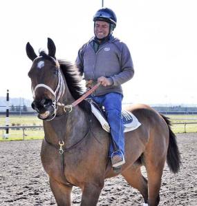 Exercise rider Pedro Vera Enriquez takes one of trainer Jeff Metz’s Thoroughbreds for a gallop at Emerald Downs last week. The Auburn track opens its 21st season Saturday