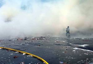 Firefighters attack a three-alarm blaze on Wednesday afternoon at the International Paper Co.