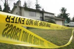 Crime scene tape Friday at the Panther Lake home where the deaths of married couple Joe and Karen Housely occurred.