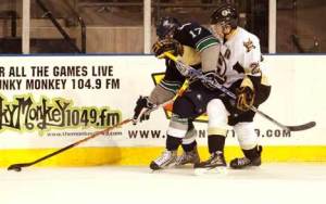 Thunderbird Sena Acolatse takes a stick to the face from Bruins defender Brandon Manning Sept. 25 as they fight for the puck.