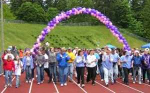 Participants in the 2007 Kent Relay for Life do a lap together at French Field during the opening ceremony of the relay. Organizers are hoping to raise funds and cancer awareness with the event.