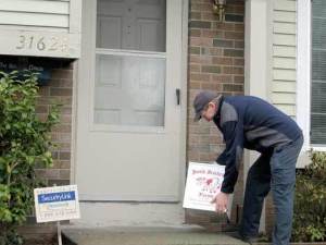 Smith Brothers Farms Driver Terry Gillihan places a box at the home of a new customer along his route. Gillihan said he delivers to approximately 200 homes everyday.