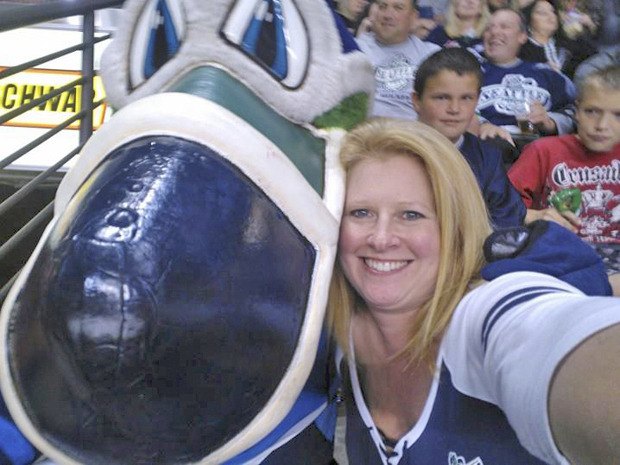 Superfan Karen Kangas and Cool Bird take in the T-Birds' Oct. 6 against the Everett Silvertips.