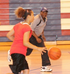 New Kent-Meridian girls basketball coach Brett Drewery takes a moment during drills to discuss defense with Sazurice Williams