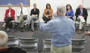 Members of the Kent City Council listen as West Hill resident Reynold Eicke asks a question Tuesday in a town hall meeting held at Kent Fire Station No. 75. About 20 citizens attended. Council members