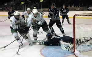 Thunderbirds goalie Calvin Pickard makes a dramatic save against a wall of Everett forwards Sept. 12