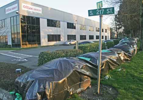 Office Depot facilities in Kent’s Cascade Commerce Park on West Valley Highway are shown with a sandbag wall to protect against flooding.  The state Legislature is working on measures to provide more flood insurance for businesses in the Green River Valley.