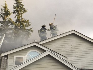 Firefighters work to put out a Covington house fire Wednesday that displaced four.