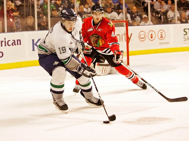 Colin Jacobs of the Seattle Thunderbirds moves the puck against the Portland Winterhawks during a game last season. Seattle opens rookie camp Aug. 25 at the ShoWare Center in Kent.