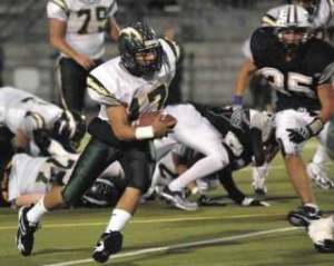 Kentridge quarterback Brandon Reiter looks for some running room against Auburn Riverside on Friday night. Reiter helped the Chargers upend the Ravens