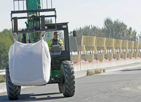 A Kent city maintenance worker uses a forklift in October to move a super sandbag out of the filling area to a holding pile before placing them along portions of the Green River levee system in Kent. The city's maintenance crews were honored by the Kent City Council this month for their efforts placing all the sandbags in such a short time.