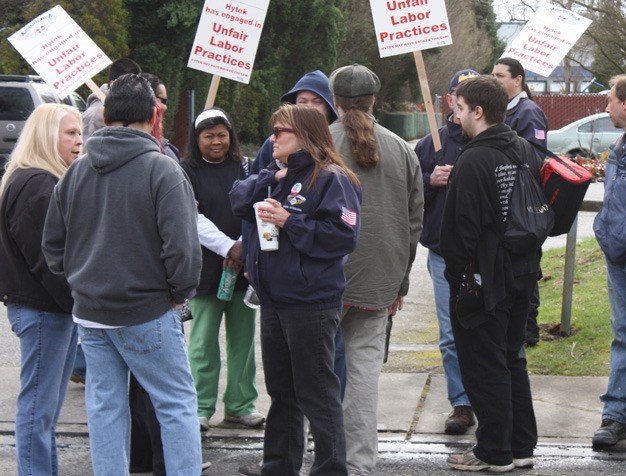 Informational pickets from the Machinists Union walk in front of Hytek Finishes in Kent to support company employees seeking a new contract.