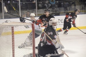 The T-Birds' Shea Theodore fires a shot at Cougars goalie Mac Engel. Theodore had two goals in the win.